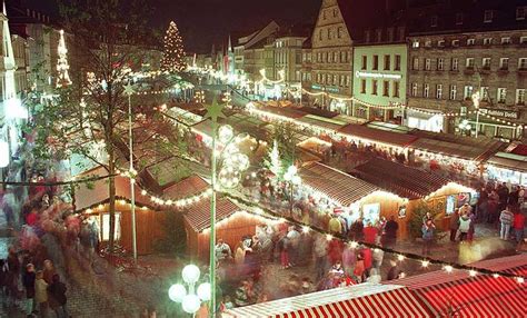 an aerial view of a christmas market at night