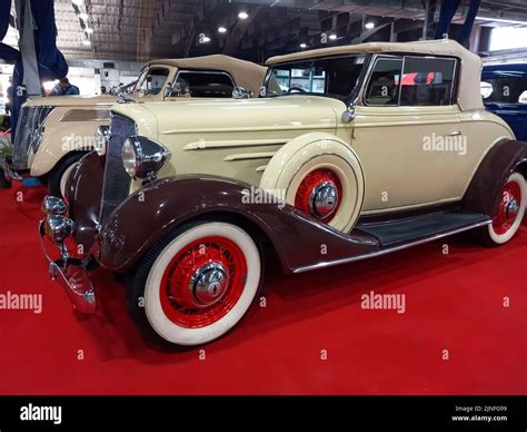 Old vintage beige brown 1934 Chevrolet Chevy Master coupe cabriolet by GM on a red carpet ...
