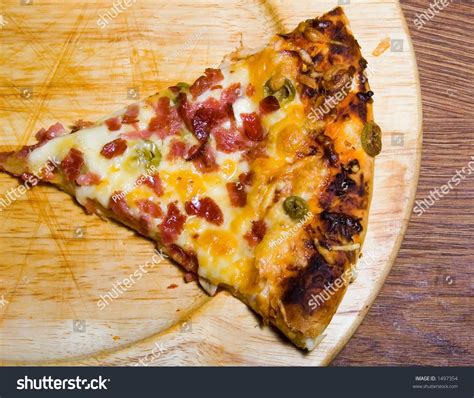 Cut Tasty Pizza Triangle On Wooden Plate Stock Photo 1497354 : Shutterstock