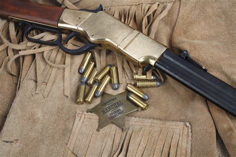 Wild West Repeating Rifle with Ammunition and Sheriff Badge Stock Photo ...