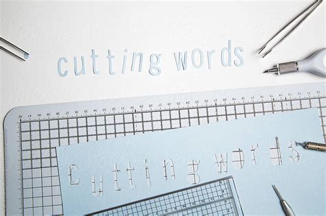 Cutting words, cut out of paper... by Catherine MacBride - Stocksy United