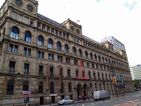 an old building on the corner of a street with cars parked in front of it