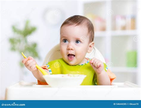 Happy Baby Kid Eating Food Itself with Spoon Stock Image - Image of breakfast, baby: 54644285