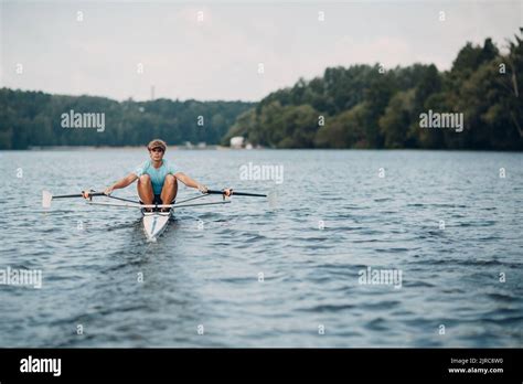 Sportsman single scull man rower rowing technique on boat. Paddle oar splash movement Stock ...