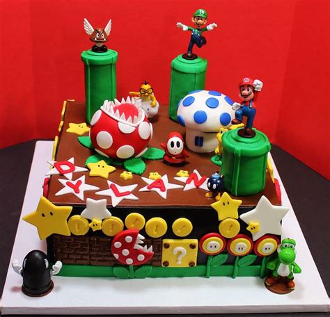 the cake is decorated with mario and luigi's house, mushrooms, stars, and other items