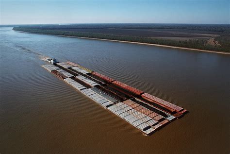 Barge Traffic On The Mississippi River by Harald Sund