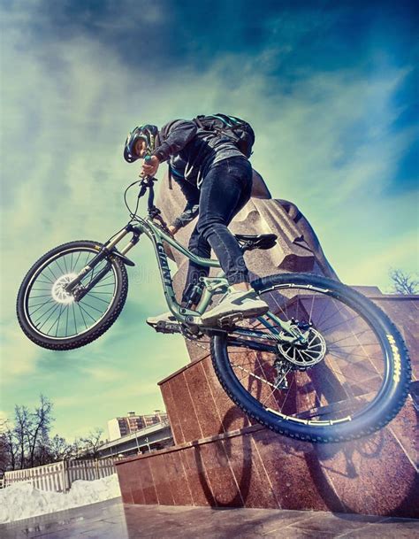 A Sports Cyclist Guy Doing Tricks on Bicycle in Urban Area. City ...