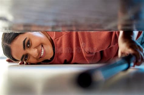 Woman Cleaning Under a Bed in Bedroom with Vacuum for the Floor To ...