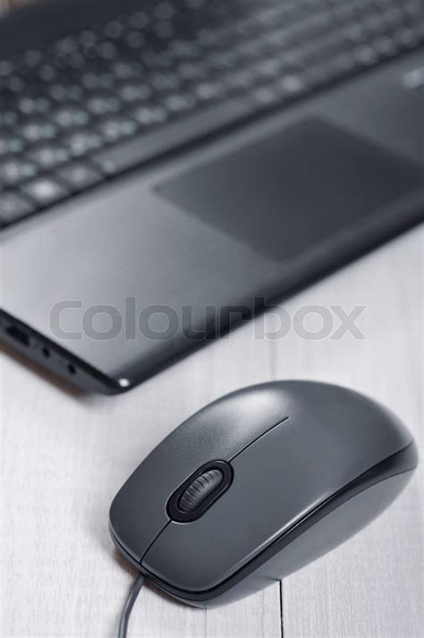 Laptop with computer mouse | Stock image | Colourbox