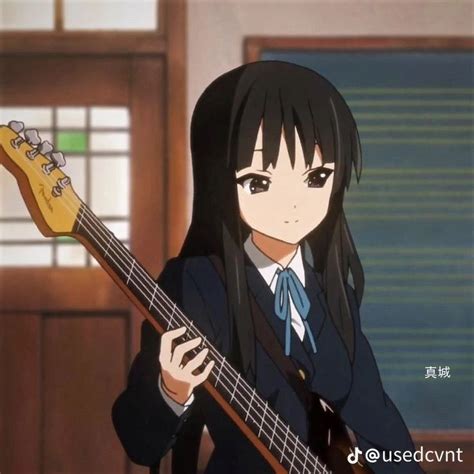 an anime girl with long black hair is holding a bass guitar in her right hand