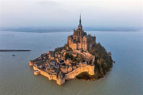 Stone castle on the oasis of Mont Saint-Michel, France | World heritage sites, Wonders of the ...