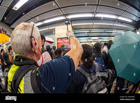 Journalists crowd around protestors in a shopping mall in Hong Kong ...