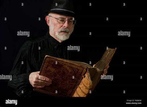 Portrait of award winning poet Peter Daniels holding a giant antique book Stock Photo - Alamy