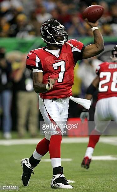 Quarterback Michael Vick of the Atlanta Falcons delivers a pass... | Michael vick, Nfl football ...