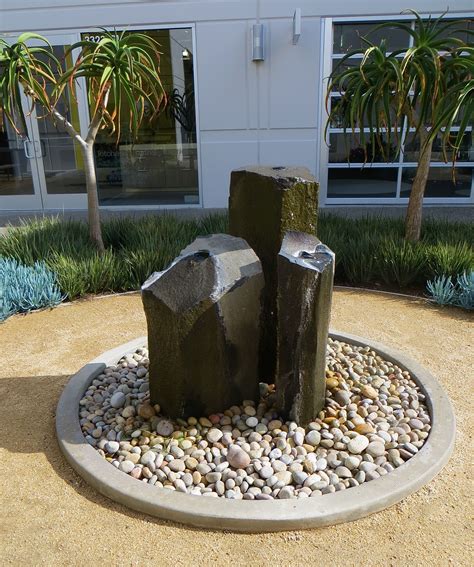 two rocks are placed in the middle of a circular rock garden