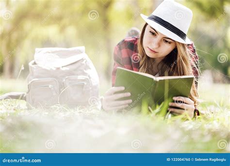 Reading a book at park stock photo. Image of sitting - 122004760