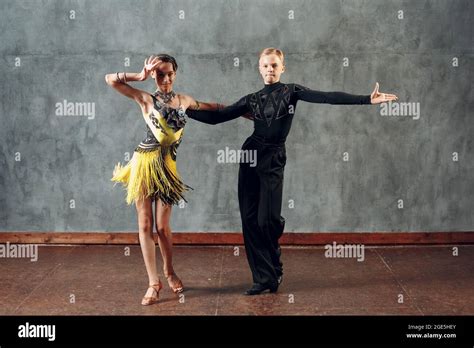 Young couple dancers dancing ballroom dance cha-cha-cha Stock Photo - Alamy