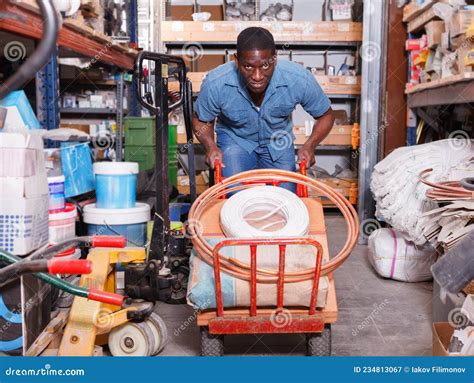 Focused African American Carrying Handbarrow with Construction Supplies Purchased Stock Image ...