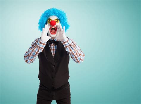 Clown screaming with hands in mouth Photo | Free Download