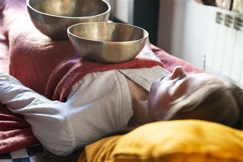 Tibetan Singing Bowls in Sound Therapy in Spa Center Over a Woman Body Stock Image - Image of ...