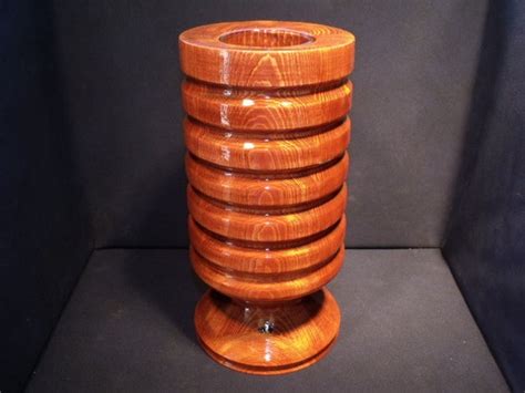 Decorative lathe turned wooden vase with glass insert.