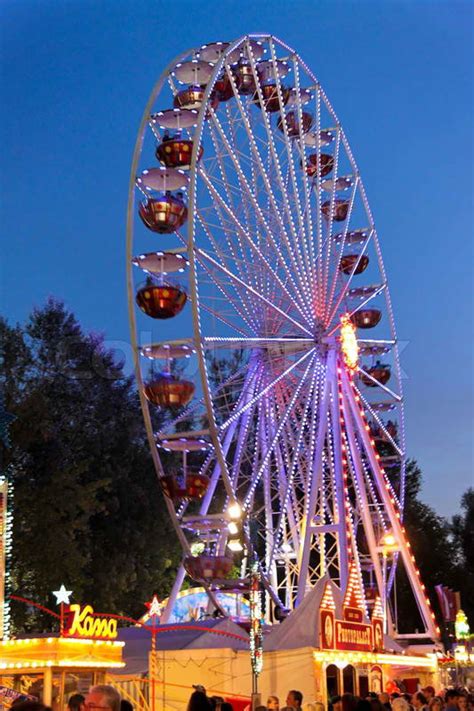 Ferris wheel with lights on a fairground at night | Stock Photo | Colourbox