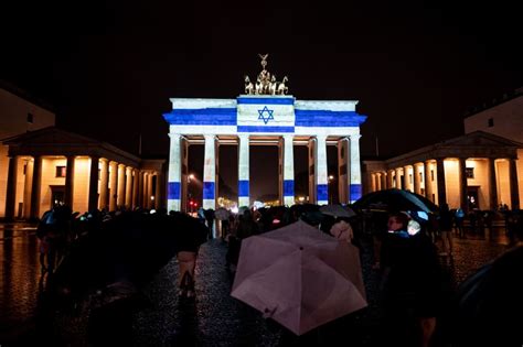 Landmark sites across the globe from New York to Berlin lit in blue and ...