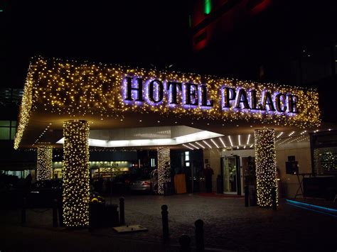 the entrance to hotel palace lit up at night