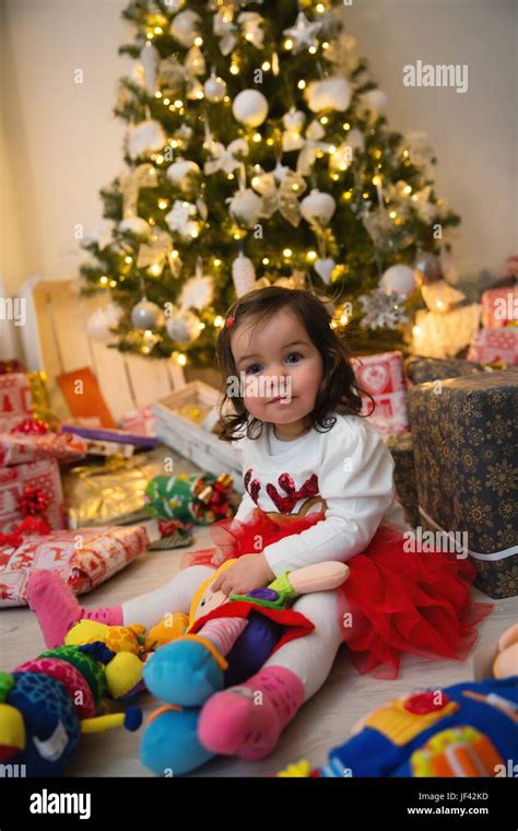 Baby and Christmas tree Stock Photo - Alamy