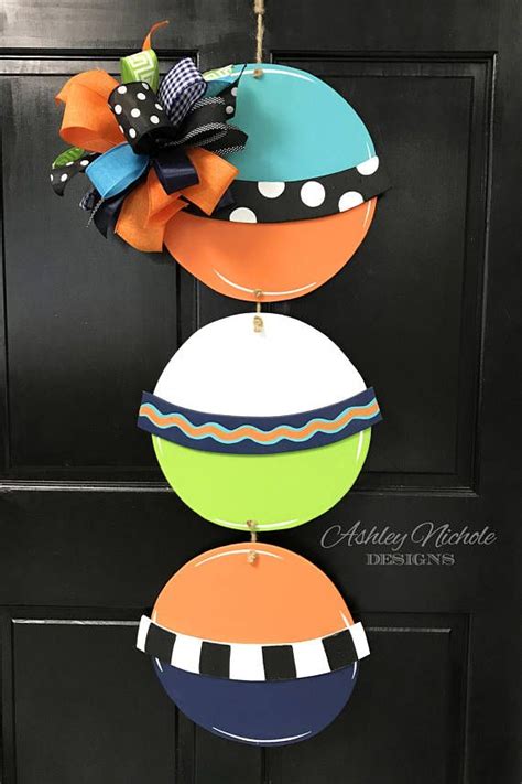 These hand painted wooden buoys are a great way to decorate at the lake, beach or home for the ...