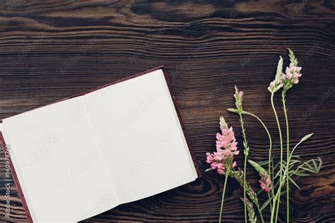 flat lay white flowers and diary on wooden background, top view. mock ...