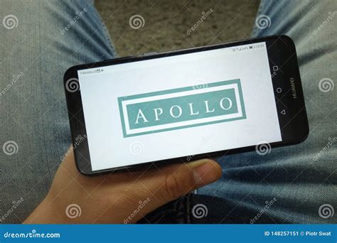 Man Holding Smartphone with Apollo Global Management, LLC Logo ...