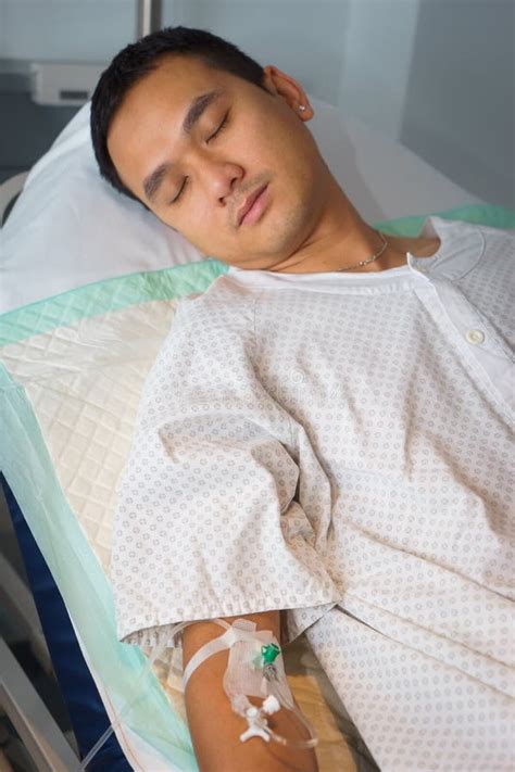 Man in hospital bed asleep stock photo. Image of asia - 48076606