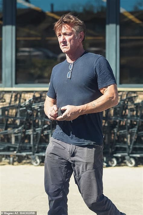 Sean Penn, 61, shows off his muscles and tattoos in a form-fitting navy ...