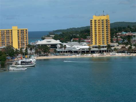 boats are in the water near hotels and beach