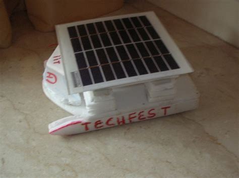 a small white toy with a solar panel on top