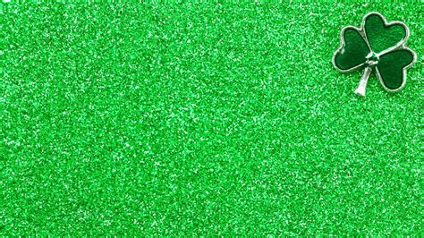 Download A Green Glitter Background With A Shamrock | Wallpapers.com