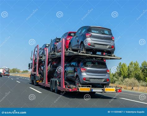 Car Carrier Trailer With Cars On Bunk Platform. Car Transport Truck On The Highway Royalty-Free ...