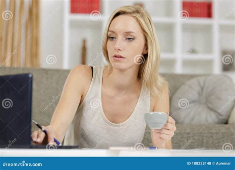 Young Beautiful Woman Having Coffee while Using Laptop Stock Photo - Image of casual, beauty ...