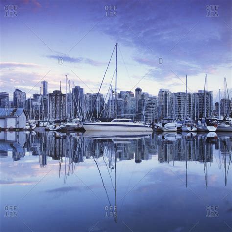 Coal harbor and cityscape at dusk stock photo - OFFSET