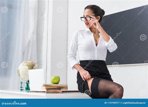 Young Teacher in Stockings Sitting on Desk Stock Image - Image of ...