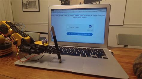 A Robotic Arm Successfully Beats an 'I Am Not a Robot' CAPTCHA Using a Stylus on the Trackpad