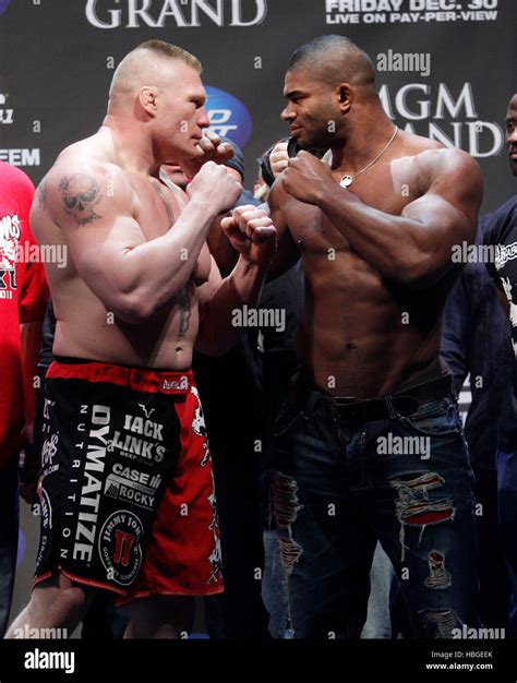 UFC fighters Brock Lesnar, left, and Alistair Overeem square off during the weigh-ins for UFC ...