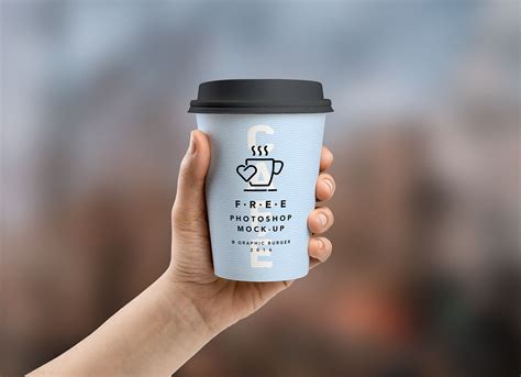 Free Coffee Paper Cup in Hand Mockup PSD - Good Mockups