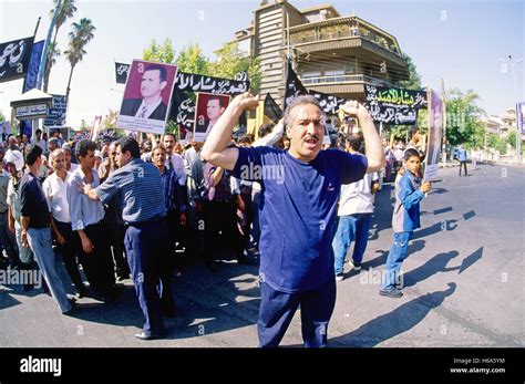 Government faithfuls chant Pro-Al-Assad slogans. Thousands of Syrians ...