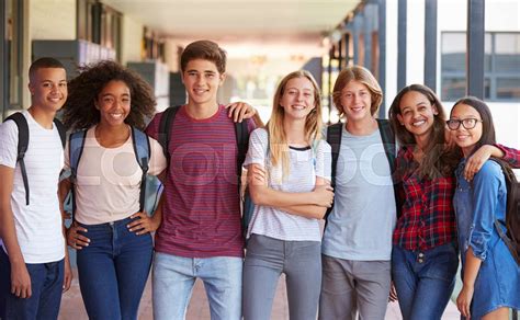 Teenage classmates standing in high school hallway | Stock image ...