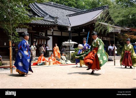 Kemari players in action where the aim is to keep the ball up in the air by kicking it and then ...