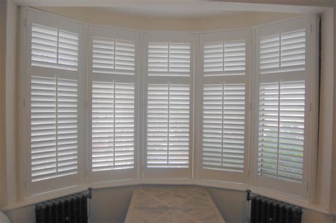 Bay window with full height shutters in 63mm slat size, silk white ...