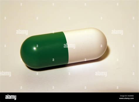 Green and white medical pill. Antibiotic capsule Stock Photo - Alamy