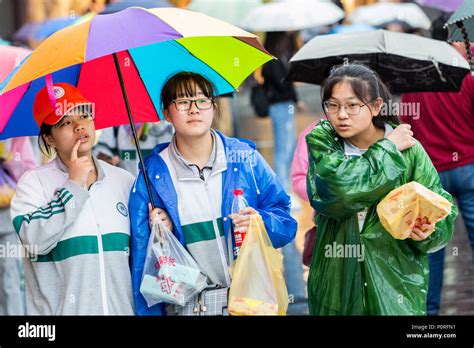 Nanjing, Jiangsu, China. Young Chinese Women Shopping in the Rain Stock ...